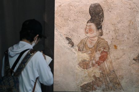 (miniature) Un touriste admire une peinture murale de la dynastie Tang (618-907) au Musée d'histoire du Shaanxi