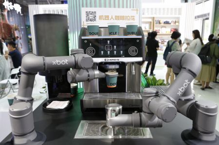(miniature) Un robot à café à deux bras développé de manière indépendante par l'entreprise prépare du café durant la Foire internationale du commerce des services de Chine (CIFTIS) 2023