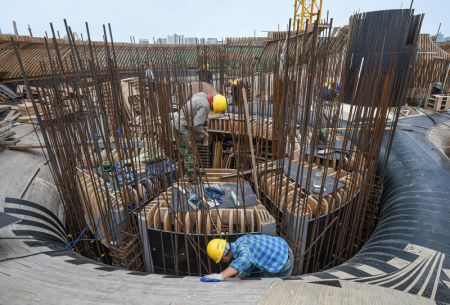 (miniature) Des ouvriers travaillent dans le site de construction de la Bibliothèque Wormwhole dans la baie de Haikou